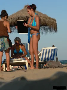 A bunch of hot babes on the beach in thong bikinis