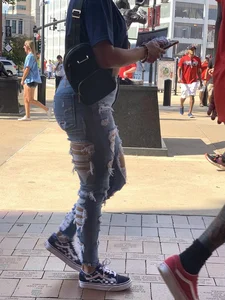Bunch of girls in various outfits at a Cardinals baseball game