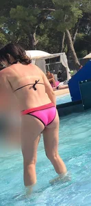 Sexy girl at the pool in pink bikini