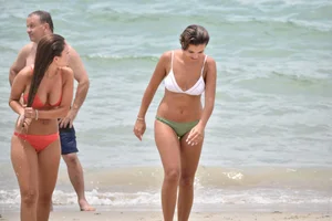 Two sexy ass girls on the beach in bikinis