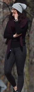 Brunette with glasses on the phone in tight patterned leggings