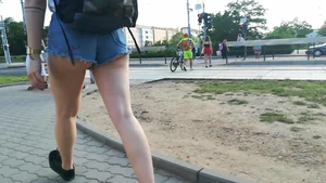 Girl walking in denim shorts showing some of her ass cheeks