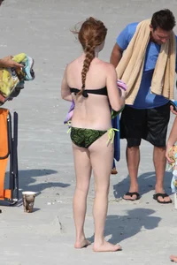 Pale redhead teen in bikini on the beach