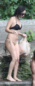Beautiful girl at the pool in black and tan bikini