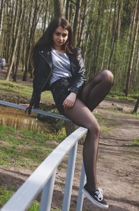 Teen JB in Leather Jacket and Black Pantyhose Sitting on the Bannister in the Park