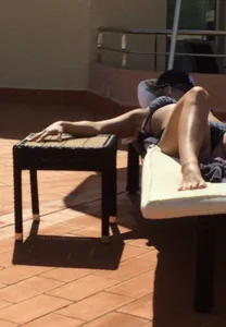 Blonde laying out in a blue bikini with a sexy body