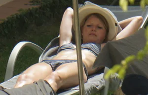Skinny girl laying out in her bikini has pussy lip slip