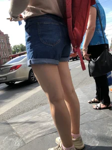 Closeup of nice legs and booty in denim shorts on a crosswalk