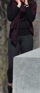 Brunette with glasses on the phone in tight patterned leggings
