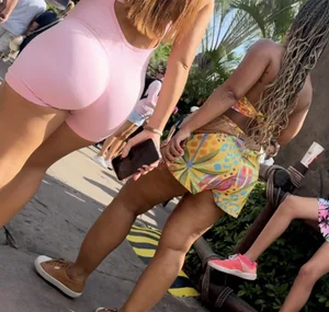 Latina with a bubble in a one piece at amusement park