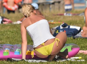 Blonde looking sexy in a yellow bikin