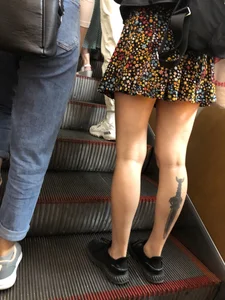 Candid Girl in a Skirt With a Tattoo on Her Calf Subway Escalator Creepshots Gallery