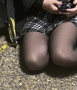 Teen in a Skirt And Black Pantyhose Sitting on the Floor - Slim Legs Closeup