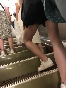 Slim legs closeup on a subway escalator creepshots