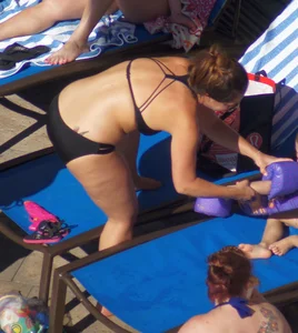 Milf laying out in black bikini by the pool