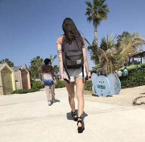 Candid hottie in shorts with a backpack