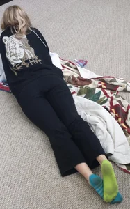 Girl wearing dirty socks lyign on the floor