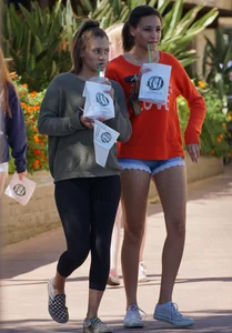 Brunette in tiny shorts walking with her sexy friend in leggings