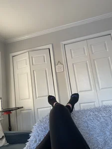 Crossed Legs in Leggings And Feet in Socks Home Selfie