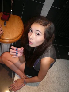 Girl sitting on the floor in the toilet