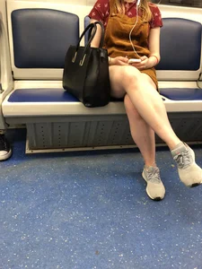 Girl with Hot Lets Sitting in a Subway Train - a Candid Peek under Skirt
