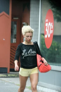 Blonde looking sexy walking in short yellow shorts