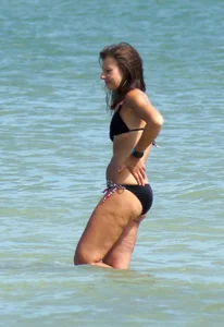 Older mature beach lady in a black bikini