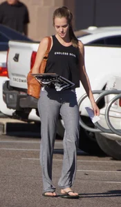 Sexy girl in the parking lot in tight grey sweatpants