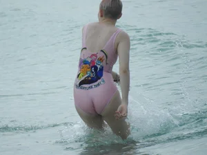 Miley Cyrus' friend in pink see through swimsuit showing nipples and pussy hair