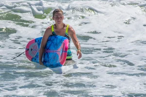 Candid girls surfing on the beach