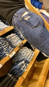 Teen in tight jeans looks to buy another pair