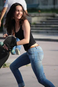 Hot brunette skateboarder in tight jeans and with hard nipples