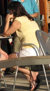 Lady in flop flops while eating showing her feet