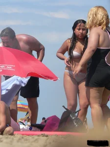 Couple of thick beach teens in little thong bikinis