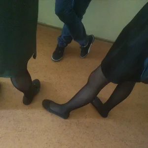 Thin Legs of College Female Students in Skirts, Black Pantyhose And Flats Photos