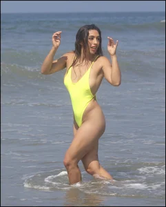 Sexy ass beach babe in a yellow thong swimsuit
