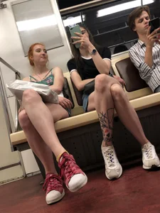 Two Girls With Hot Long Legs in Mini Shorts and Sneakers in the Subway Train Candid Photo Gallery