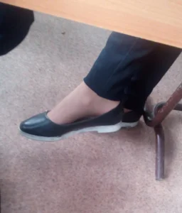 Teen Girl’s Feet in Flats Closeup under Desk in College Classroom - Crossed Legs in Pantyhose