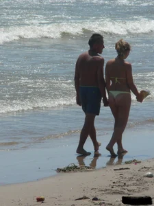 Sexy blonde on the beach in a yellow thong bikini