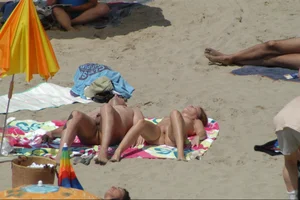 Girls on a nude beach in Sitges, Spain