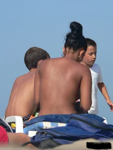 Hot ass topless beach girl with great tits lets her little brother oil up her ass in thong bikini