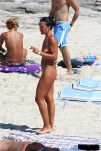 Smoking milf at a nude beach with a hairy pussy