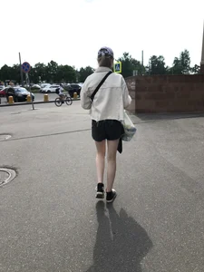 Cute candid teen with pale slim legs in shorts