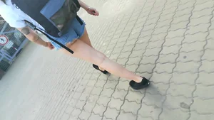 Girl walking in denim shorts showing some of her ass cheeks