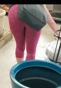 Milf shopping with a nice ass in tight maroon leggings