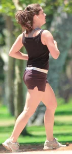 Cute girl running in short shorts