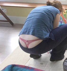 Girl Squatting with Her Hot Panties Sticking Out from under Pants Candid Photo