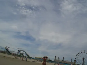 Milf laying out on a beach in Maine in her little thong