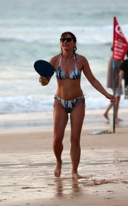 Older lady playing on the beach in her bikini