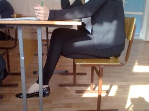 Teen JB in Tight Pants and Flats Sitting in Classroom